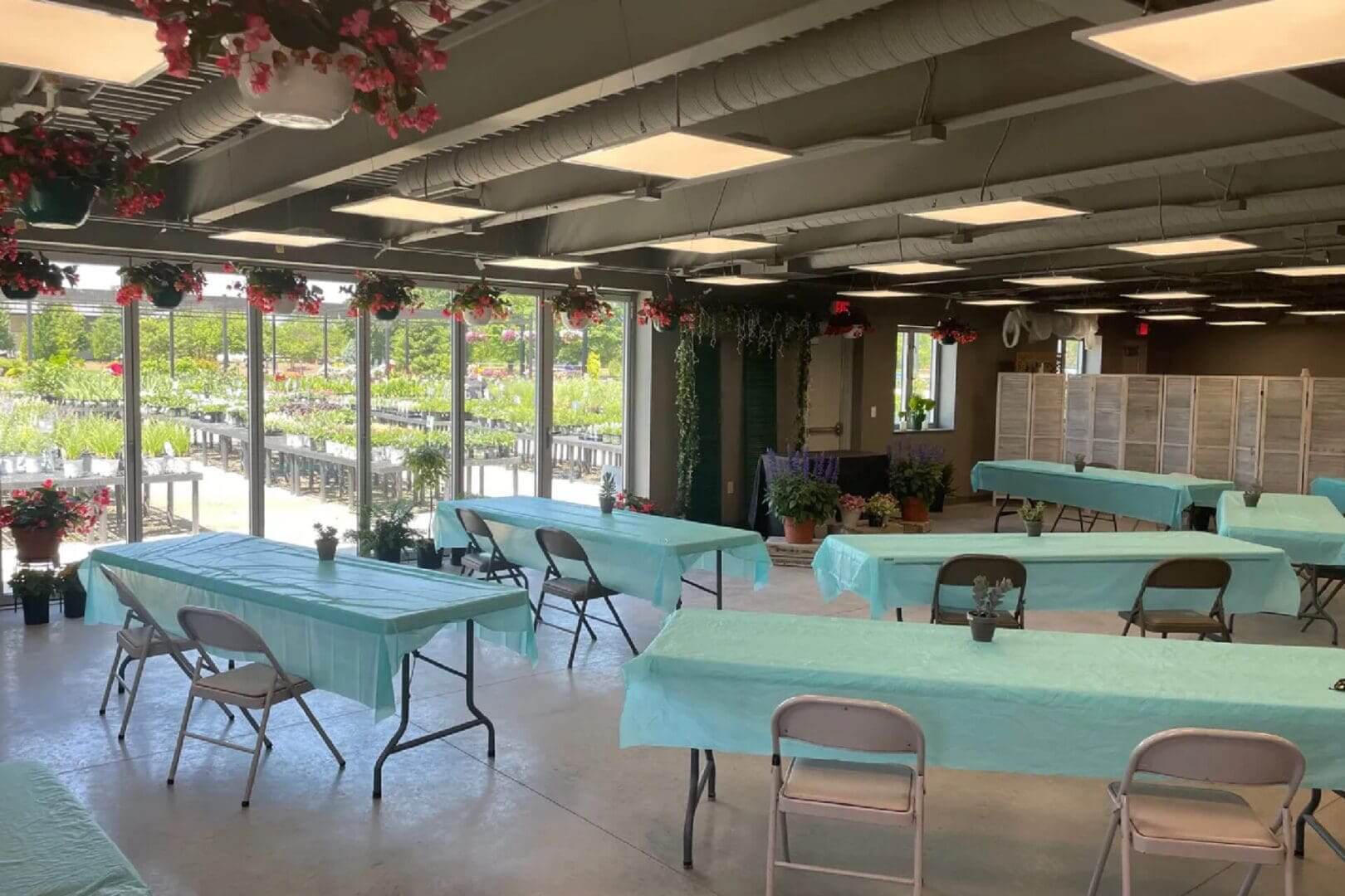 Indoor garden event space with tables.