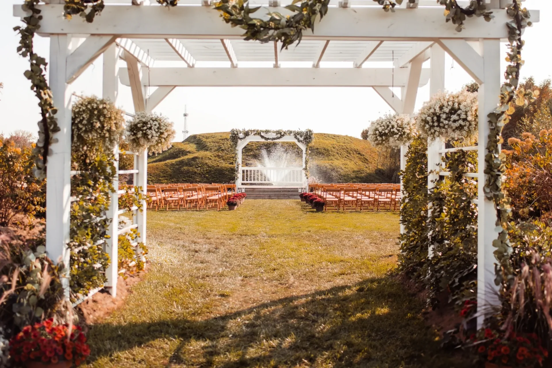 White pergola wedding ceremony with fountain