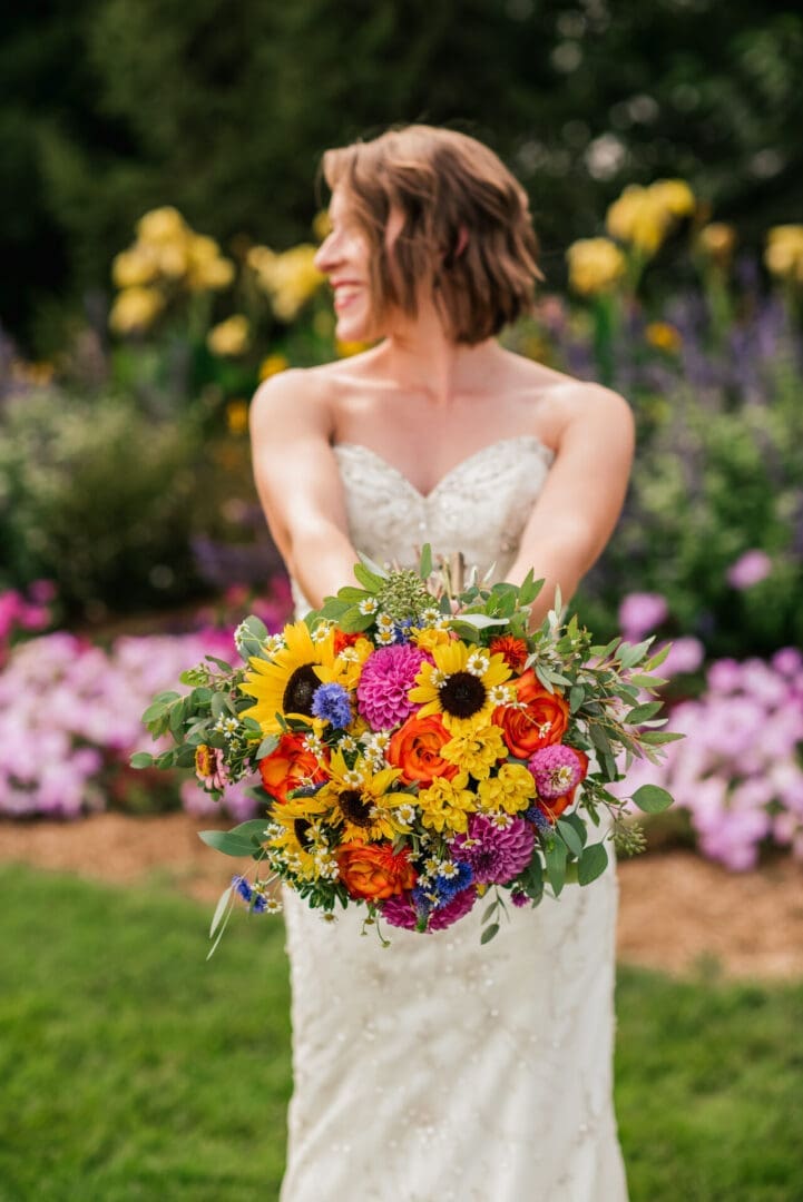 Bride holding vibrant multicolored bouquet