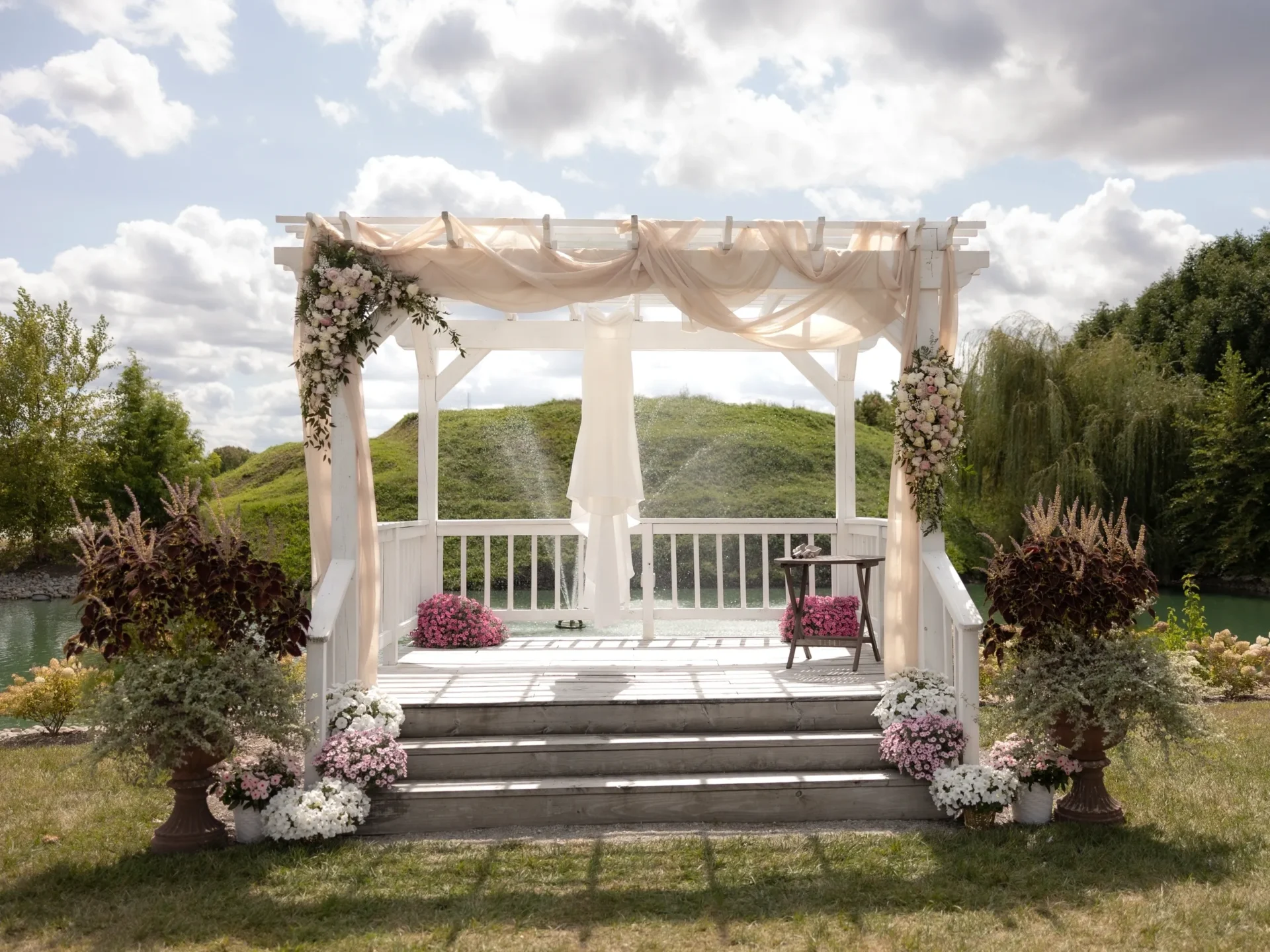 Outdoor lakeside wedding arch with flowers