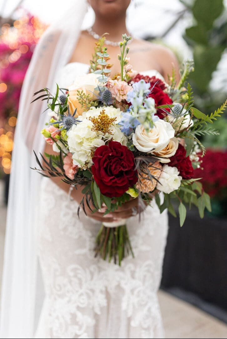 Bride holding red and white floral bouquet